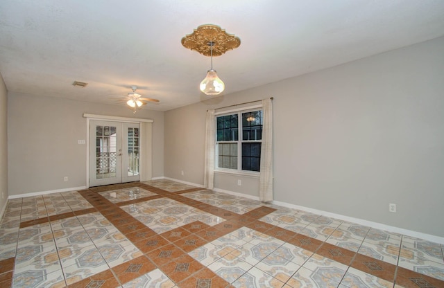 10131 Tangiers Rd, Houston, TX 77041 - spare room featuring french doors, a ceiling fan, inlaid floor details, and tile patterned flooring