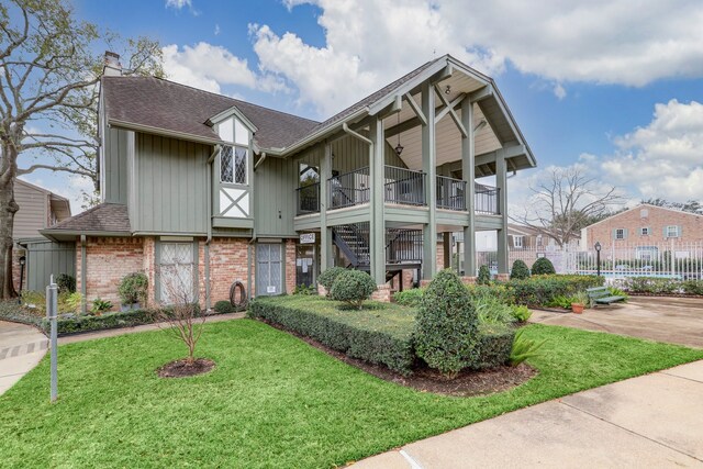 2065 Winrock Blvd Unit 55, Houston, TX 77057 - view of front of home featuring brick siding, board and batten siding, a chimney, a shingled roof, and stairs