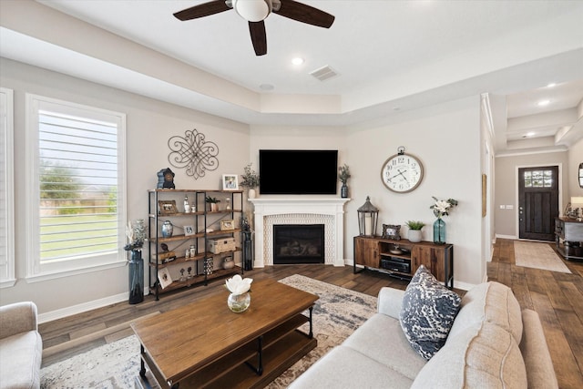 5946 Wedgewood Heights Way, Houston, TX 77059 - living area featuring wood finished floors, ceiling fan, a tile fireplace, a tray ceiling, and recessed lighting