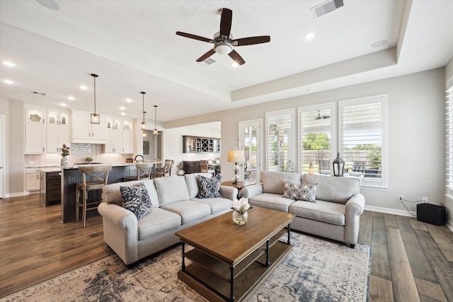 5946 Wedgewood Heights Way, Houston, TX 77059 - living room featuring dark wood-type flooring, ceiling fan, recessed lighting, and a raised ceiling