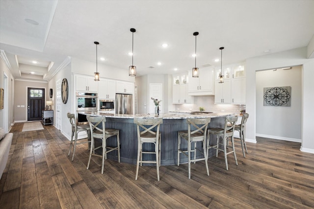 5946 Wedgewood Heights Way, Houston, TX 77059 - kitchen with appliances with stainless steel finishes, dark wood finished floors, decorative backsplash, white cabinetry, and glass insert cabinets