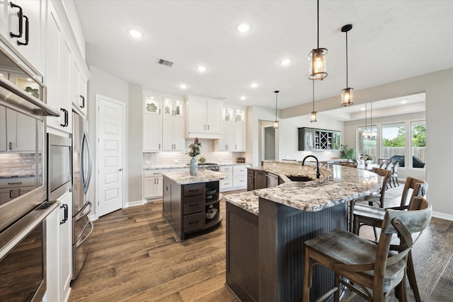 5946 Wedgewood Heights Way, Houston, TX 77059 - kitchen featuring a large island, dark wood-type flooring, recessed lighting, backsplash, and glass insert cabinets