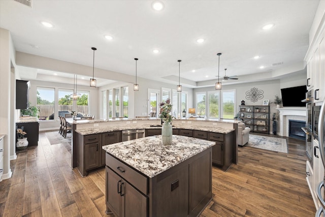5946 Wedgewood Heights Way, Houston, TX 77059 - kitchen featuring a large island with sink, open floor plan, stainless steel dishwasher, dark brown cabinetry, and recessed lighting