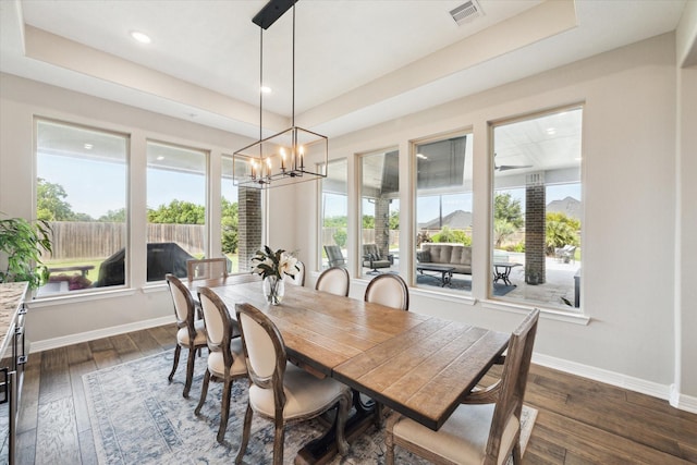 5946 Wedgewood Heights Way, Houston, TX 77059 - dining area with a chandelier, healthy amount of natural light, dark wood-style flooring, recessed lighting, and a tray ceiling