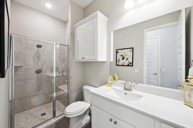 5946 Wedgewood Heights Way, Houston, TX 77059 - bathroom with vanity, a shower stall, wood finished floors, and recessed lighting