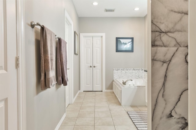 826 E 29th St, Houston, TX 77009 - bathroom featuring a bath, tile patterned floors, and recessed lighting