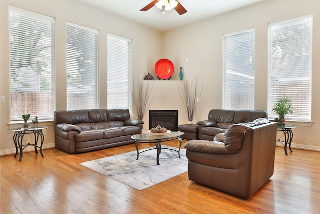 826 E 29th St, Houston, TX 77009 - living area featuring a ceiling fan, light wood finished floors, and a glass covered fireplace