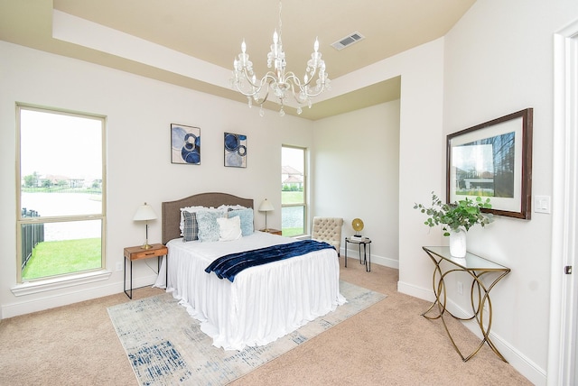 5450 Pudman River Ln, Sugar Land, TX 77479 - bedroom featuring a chandelier, light carpet, and a water view