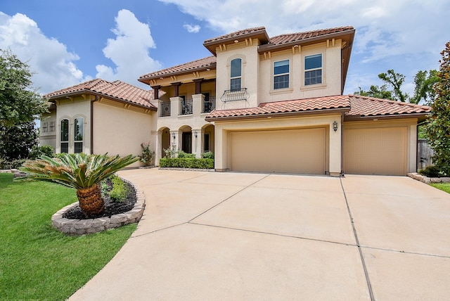 5450 Pudman River Ln, Sugar Land, TX 77479 - mediterranean / spanish-style home featuring concrete driveway, a tile roof, stucco siding, a balcony, and an attached garage