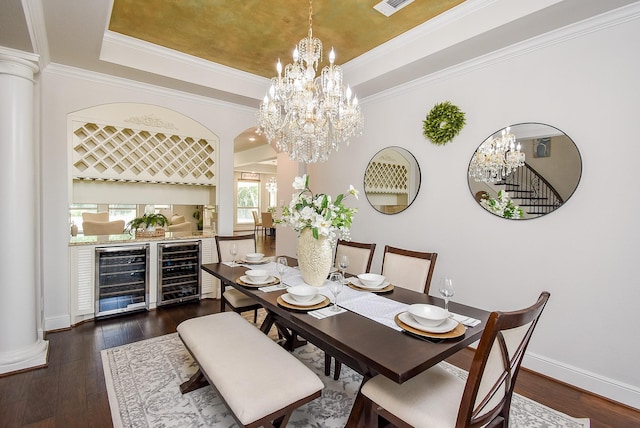 5450 Pudman River Ln, Sugar Land, TX 77479 - dining room with wine cooler, a chandelier, a raised ceiling, and crown molding