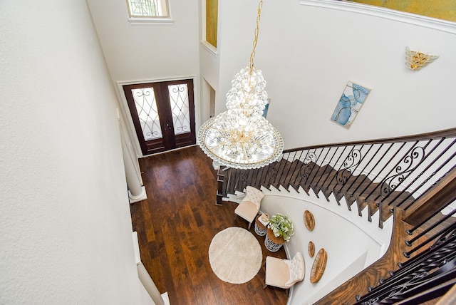 5450 Pudman River Ln, Sugar Land, TX 77479 - entryway featuring a chandelier, wood finished floors, plenty of natural light, and a towering ceiling
