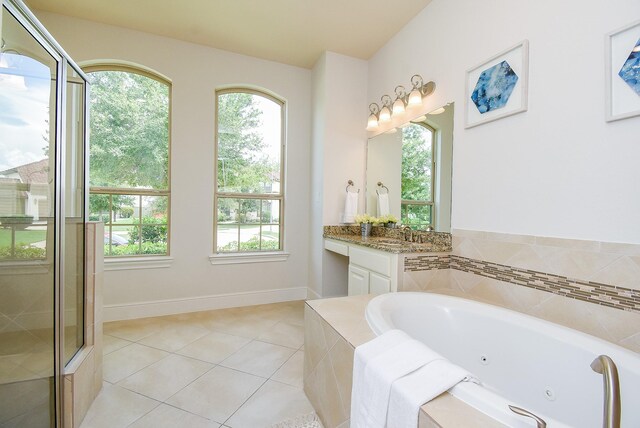 5450 Pudman River Ln, Sugar Land, TX 77479 - bathroom featuring tile patterned floors, a jetted tub, vanity, and a tile shower