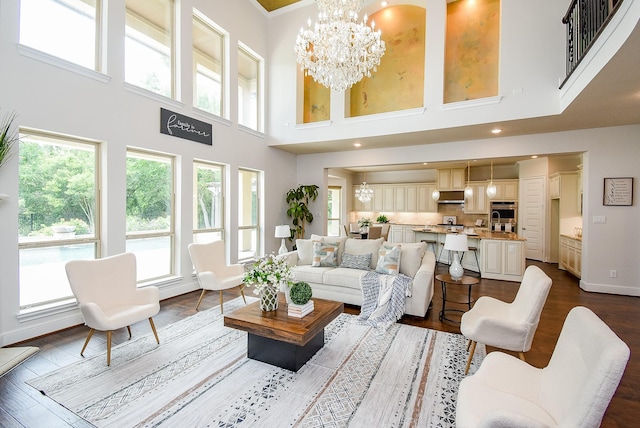 5450 Pudman River Ln, Sugar Land, TX 77479 - living area featuring a chandelier, dark wood-style floors, and a high ceiling