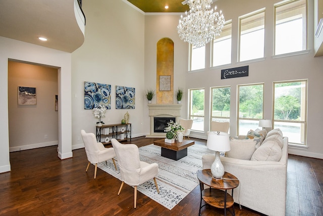 5450 Pudman River Ln, Sugar Land, TX 77479 - living room with arched walkways, a towering ceiling, a glass covered fireplace, dark wood-style floors, and recessed lighting