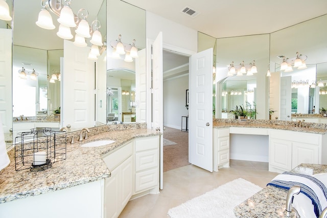 5450 Pudman River Ln, Sugar Land, TX 77479 - full bathroom with a chandelier, two vanities, and tile patterned floors