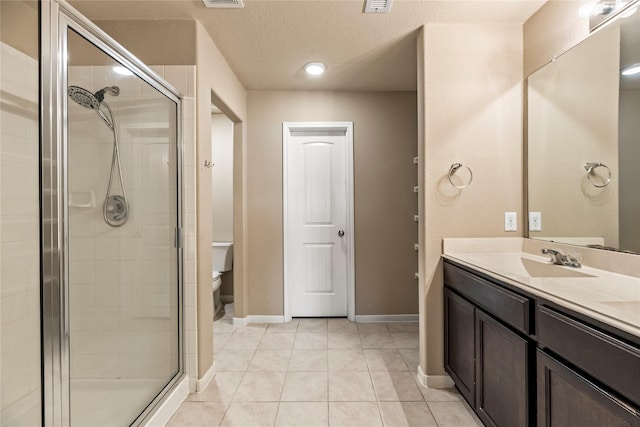 2926 Indwarra Ct, Katy, TX 77494 - bathroom featuring a stall shower, vanity, tile patterned flooring, and a textured ceiling
