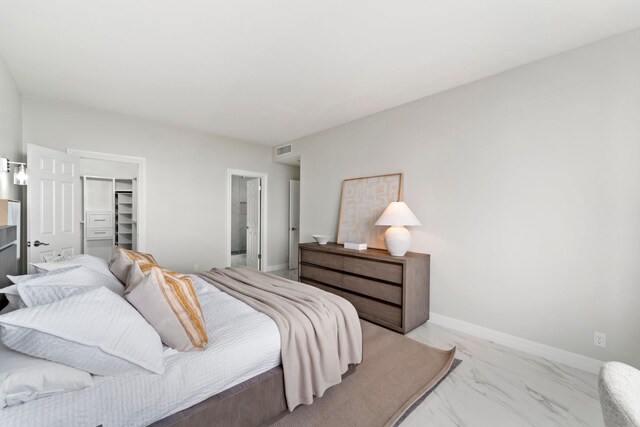 651 Bering Dr Unit 303, Houston, TX 77057 - bedroom featuring light marble finish floors, a spacious closet, and a closet