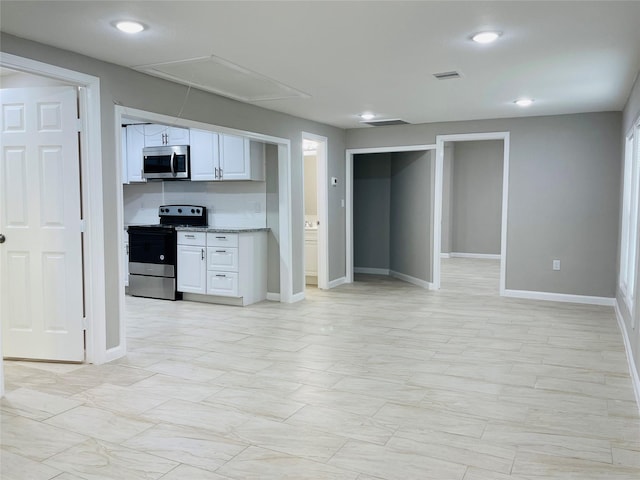 506 N Hackberry St, Sweeny, TX 77480 - kitchen with stainless steel appliances, white cabinetry, open floor plan, recessed lighting, and light stone counters