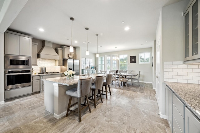 2705 Veranda Vly, League City, TX 77573 - kitchen with stainless steel appliances, custom range hood, gray cabinetry, backsplash, and recessed lighting