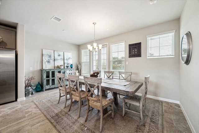 2705 Veranda Vly, League City, TX 77573 - dining space featuring a chandelier and light stone finish floors