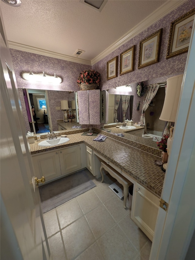 14453 Misty Meadow Ln, Houston, TX 77079 - bathroom with ornamental molding, double vanity, a textured ceiling, and tile patterned floors