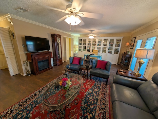 14453 Misty Meadow Ln, Houston, TX 77079 - living area with a textured ceiling, dark wood finished floors, ceiling fan, a glass covered fireplace, and crown molding