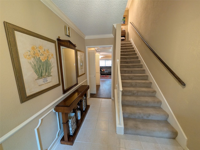 14453 Misty Meadow Ln, Houston, TX 77079 - staircase featuring tile patterned flooring, a textured ceiling, and ornamental molding