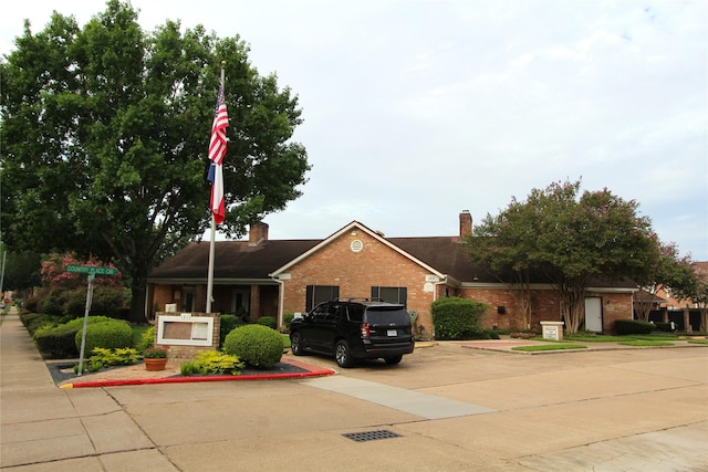 14453 Misty Meadow Ln, Houston, TX 77079 - ranch-style home featuring brick siding, a chimney, and uncovered parking