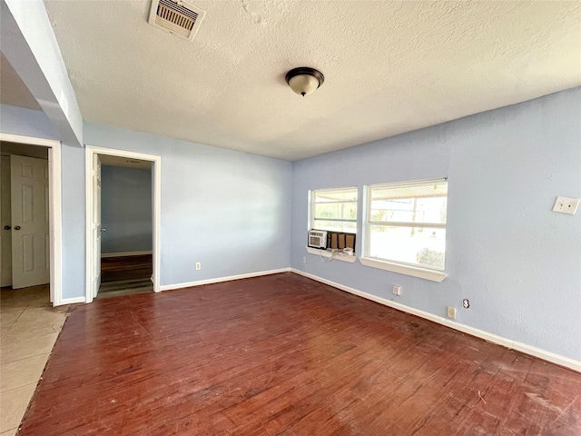 3707 Rosemont St, Houston, TX 77051 - empty room featuring a textured ceiling, wood finished floors, and cooling unit