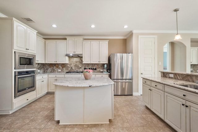 25611 Kearsley Dr, Katy, TX 77494 - kitchen with appliances with stainless steel finishes, ornamental molding, backsplash, light stone counters, and decorative light fixtures