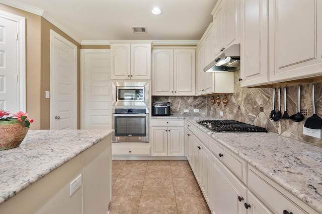 25611 Kearsley Dr, Katy, TX 77494 - kitchen featuring appliances with stainless steel finishes, under cabinet range hood, backsplash, crown molding, and light stone counters