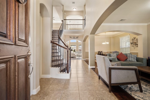 25611 Kearsley Dr, Katy, TX 77494 - foyer with stairs, arched walkways, crown molding, light tile patterned floors, and a chandelier