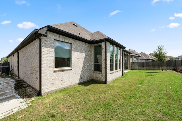 3019 Bluestem Rd, Katy, TX 77493 - back of property with a fenced backyard, brick siding, and roof with shingles