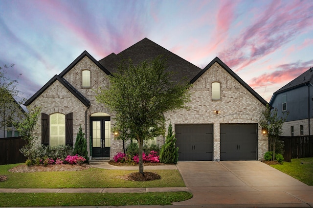 3019 Bluestem Rd, Katy, TX 77493 - french provincial home featuring concrete driveway, french doors, brick siding, and an attached garage