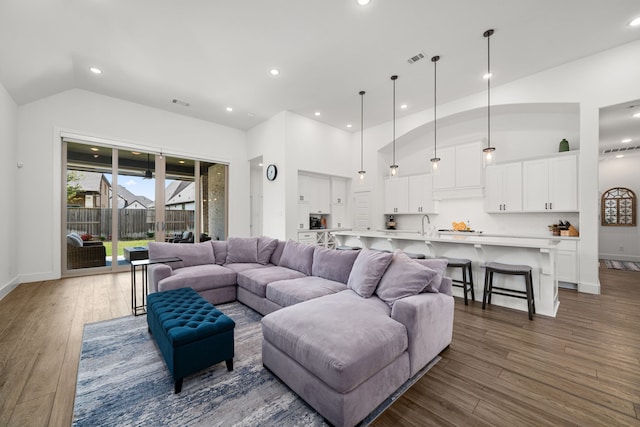 3019 Bluestem Rd, Katy, TX 77493 - living room with wood finished floors, lofted ceiling, and recessed lighting