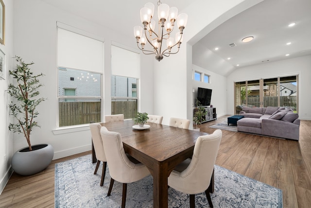3019 Bluestem Rd, Katy, TX 77493 - dining room with light wood-style floors, a chandelier, vaulted ceiling, arched walkways, and recessed lighting
