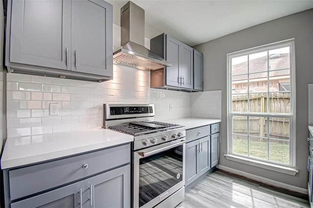 7918 Battleoak Dr, Houston, TX 77040 - kitchen with wall chimney exhaust hood, stainless steel gas stove, gray cabinets, and light countertops
