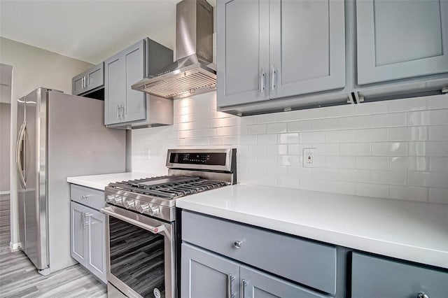 7918 Battleoak Dr, Houston, TX 77040 - kitchen with wall chimney range hood, appliances with stainless steel finishes, gray cabinets, and light countertops