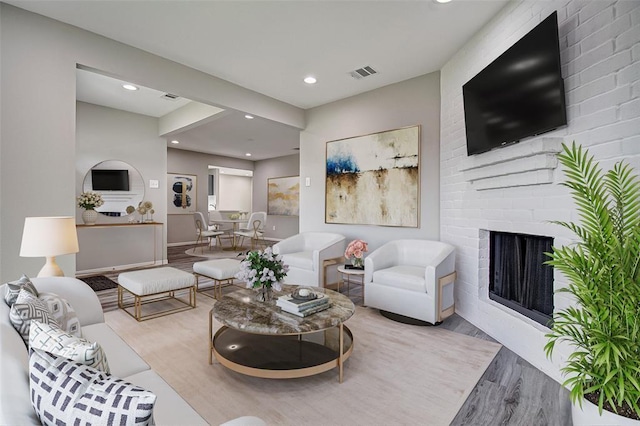7918 Battleoak Dr, Houston, TX 77040 - living room featuring wood finished floors, a fireplace, and recessed lighting