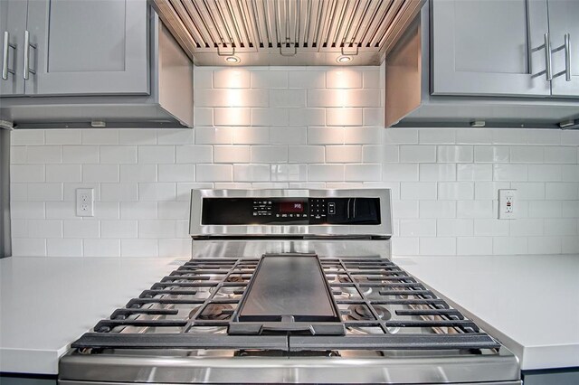 7918 Battleoak Dr, Houston, TX 77040 - kitchen with stainless steel range, gray cabinetry, backsplash, and light countertops