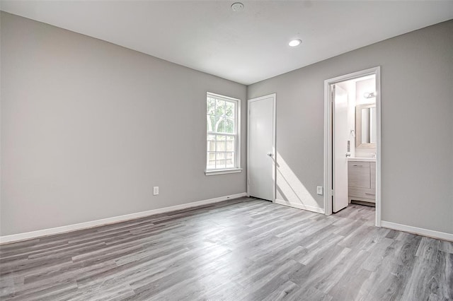 7918 Battleoak Dr, Houston, TX 77040 - unfurnished bedroom featuring light wood-style flooring, recessed lighting, and connected bathroom