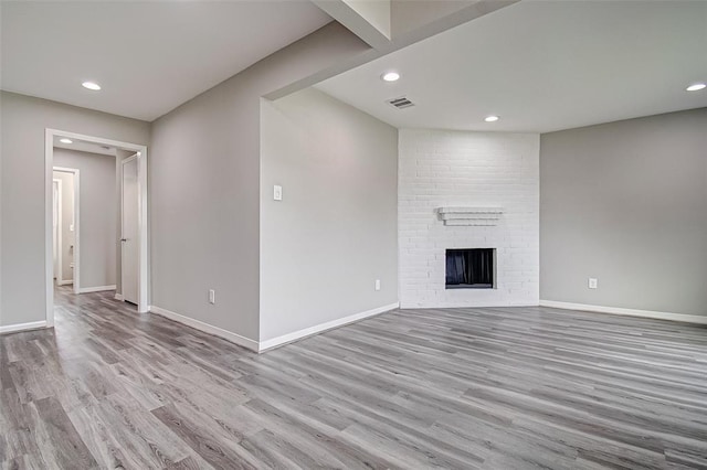 7918 Battleoak Dr, Houston, TX 77040 - unfurnished living room with wood finished floors, recessed lighting, and a brick fireplace