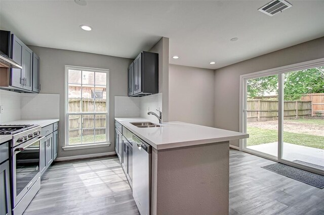 7918 Battleoak Dr, Houston, TX 77040 - kitchen with appliances with stainless steel finishes, light wood-type flooring, plenty of natural light, light countertops, and recessed lighting