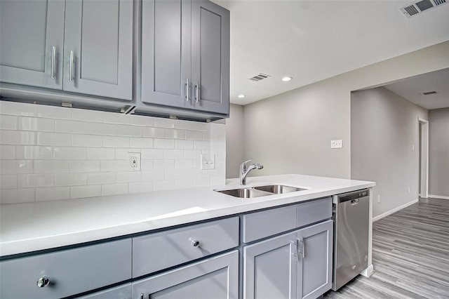 7918 Battleoak Dr, Houston, TX 77040 - kitchen with dishwasher, gray cabinets, light wood-style flooring, light countertops, and recessed lighting