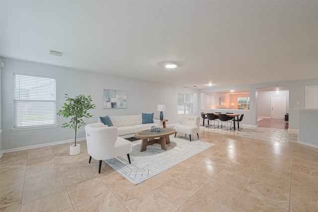 2123 Gable Hollow Ln, Katy, TX 77450 - living room featuring light tile patterned floors and baseboards