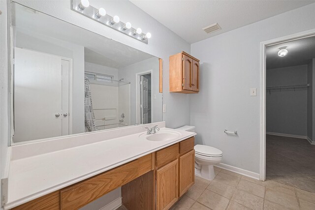 2123 Gable Hollow Ln, Katy, TX 77450 - bathroom featuring vanity, tile patterned flooring, a shower with curtain, and a walk in closet