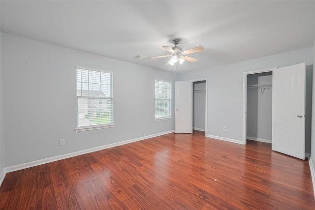 2123 Gable Hollow Ln, Katy, TX 77450 - unfurnished bedroom with two closets, wood finished floors, and a ceiling fan