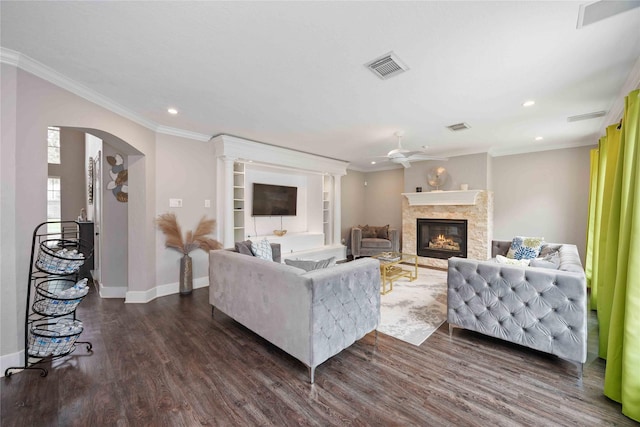 6319 Founding Dr, Katy, TX 77449 - living room featuring a ceiling fan, a stone fireplace, ornamental molding, dark wood finished floors, and recessed lighting