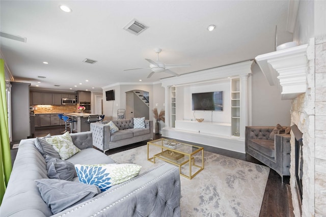 6319 Founding Dr, Katy, TX 77449 - living room featuring ceiling fan, ornamental molding, recessed lighting, wood finished floors, and stairs