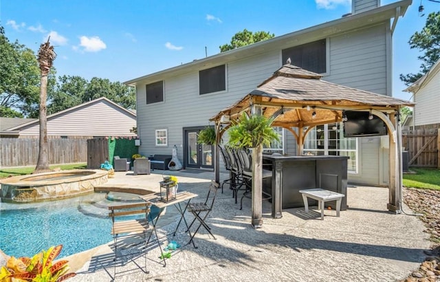 6319 Founding Dr, Katy, TX 77449 - rear view of property featuring a fenced backyard, a gazebo, a patio area, a chimney, and a pool with connected hot tub